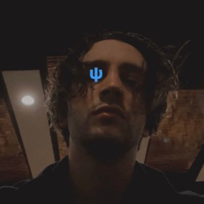 Alt text: Tyler&#39;s Twitter profile picture with blue sai logo over his right eye&quot;